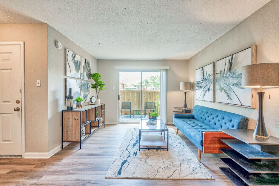 the living room has a blue couch and a blue table at The Del Sol